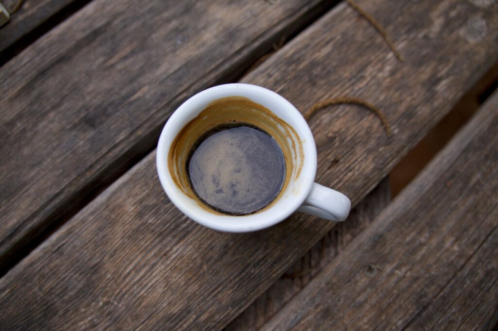 Pusta filiżanka po espresso na rustykalnym drewnianym stole
